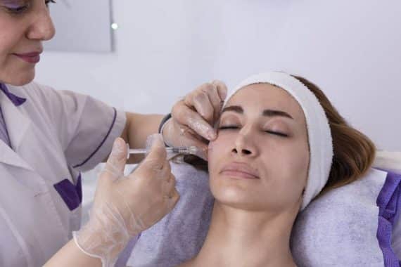 cosmetologist performing radiesse injection